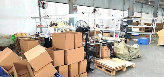 LIKA METAL workers packing hardware into cartons